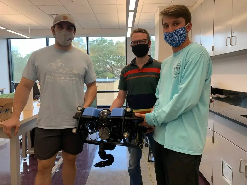 Members of the RkinD group at LSU with their Reach Alpha manipulator mounted on a Blue Robotics vehicle