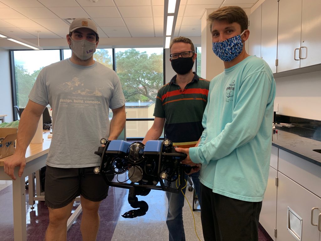 Members of the RkinD group at LSU with their Reach Alpha manipulator mounted on a Blue Robotics vehicle