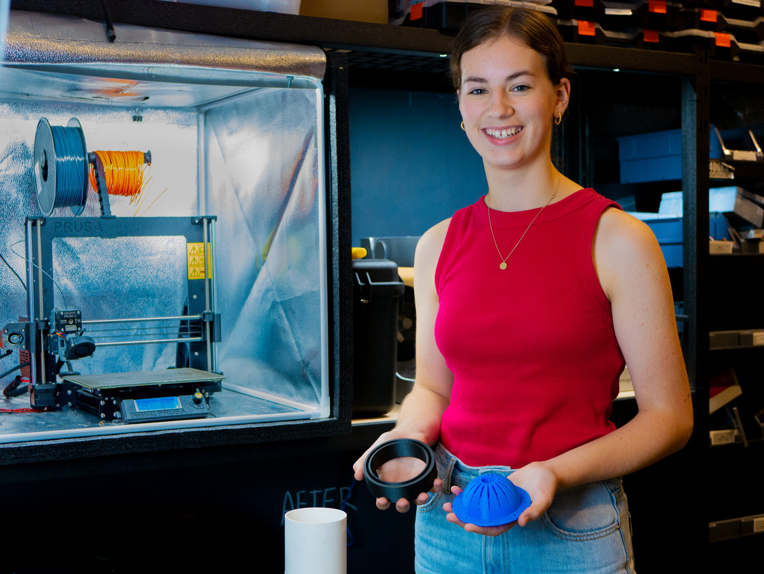 A lady with 3D printed underwater sediment sampler prototype.